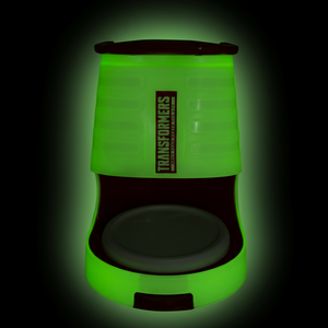 a green plastic object with a black background