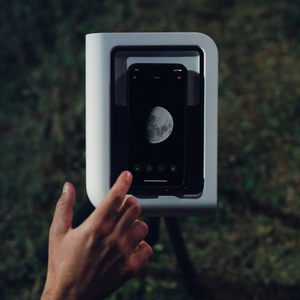 a hand touching a phone screen